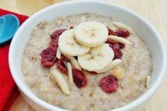 a bowl of oatmeal with bananas and strawberries