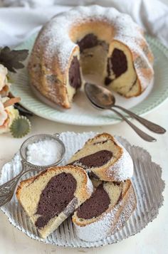 two plates with slices of cake on them and one has a slice cut from it