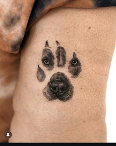 a dog's paw print on the side of a man's leg