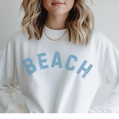 🌊 BEACH heavy blend crewneck sweatshirt ⛱️ Ribbed knit collar to retain shape after washing  🐚 No itchy side seams  🩴 Medium-heavy fabric blend 50% cotton / 50% polyester  🌴 Classic fit and crew neckline for comfy wearing experience with a clean-cut style 🏄🏽 No itchiness thanks to the gray, pearlized tear-away label 🦑 100% ethically grown US cotton  🪷 Available in colors: white, sand sport gray and dark heather SIZING:: * Sizing is unisex so runs like men's, however not overly large * Mo Aesthetic Beachy, Coastal Summer, Vacation Aesthetic, Sweatshirt Trendy, Surf Shirt, Sweatshirt Crewneck, Trendy Shirts, Clean Cut, White Sand