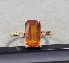 -PRODUCT TYPE - 14k GOLD ORANGE GARNET RING -MATERIAL - GOLD 14K -PURITY - 14K -STONE WEIGHT - 3.45 CARAT       -DIAMOND WEIGHT - 0.04 CARATS APPROX               -GOLD WEIGHT - 2.852 GRAMS APPROX -TOTAL WEIGHT - 3.550 GRAMS APPROX -STONE - ORANGE GARNET -STONE SIZE - 6 X 11 MM    -BAND SIZE - 2 MM We are Introducing this new collection of Gold jewelry which is distinctive and unique. We have used natural Orange Garnet of superb quality. So, here We launch this item on etsy!  If You are looking for any other sizes which are not available in variation category do contact us directly.  Anirudh Gems Store :- https://www.etsy.com/uk/shop/ANIRUDHGEMSStore?ref=search_shop_redirect -Quality is guaranteed. Our mission is always to satisfy our customers with our offerings, so just relax and place o Gem Store, Garnet Gem, Solid Gold Ring, Garnet Ring, Bridal Bands, Garnet Stone, Solid Gold Rings, Jewelry Diamond, Women Ring