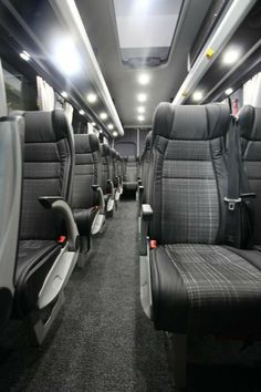 the inside of an empty bus with seats and lights on each seat is dark gray