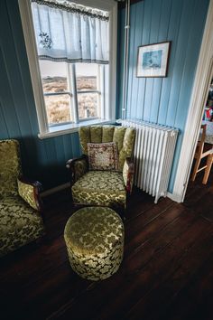 a living room with blue walls and wooden floors