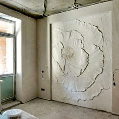 a room that has some kind of art work on the wall and is being worked on