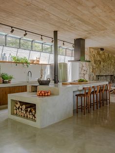 a kitchen with an oven, table and chairs in it's center island area