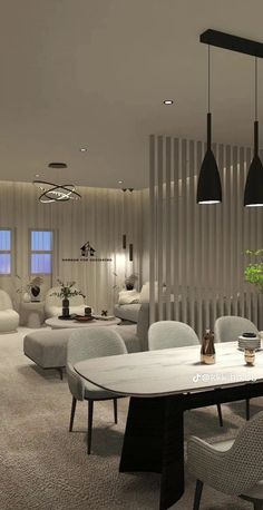 a dining room with white chairs and a table in the center, along with black pendant lights hanging from the ceiling