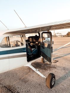 an airplane with its door open sitting on the tarmac