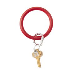 a red keychain with a metal ring and two keys hanging from it's end