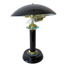 a black and gold desk lamp sitting on top of a table