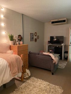 a bedroom with a bed, chair and television