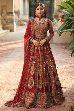 a woman in a red and gold bridal gown