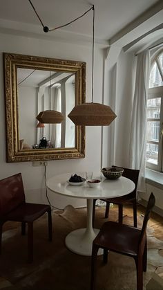 a table with two chairs and a mirror