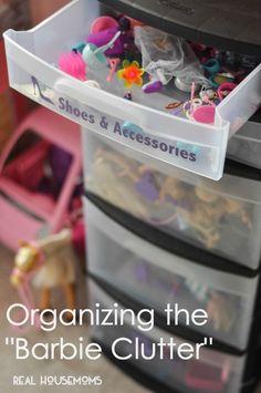 an organized drawer with plastic bins filled with clothes and accessories for barbie's closet