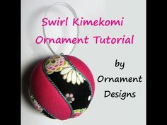 an ornament is hanging on a white background with the words swirl kimonoi ornaments