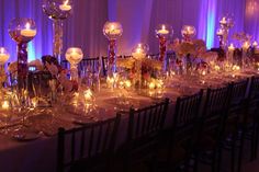 a long table is set with candles and centerpieces for an elegant wedding reception