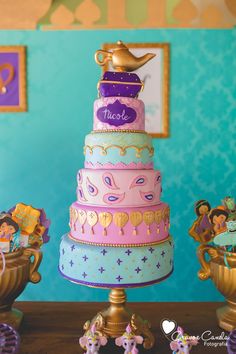 a three tiered cake sitting on top of a table next to toy figurines