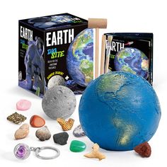 the earth kit is in front of its box and keychain with other items around it