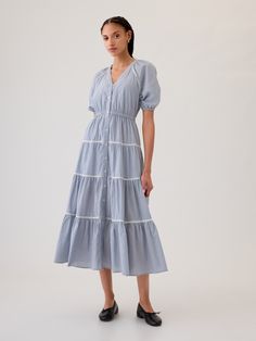 Soft cotton maxi shirtdress. V-neck, button front. Elbow puff sleeves. Tiered skirt. Certain styles have allover prints. * Fit: Relaxed. A fit & flare silhouette with an easy fit & a flared opening. * Style Note: For a more Classic fit, go down one