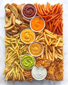 a platter filled with french fries and dips