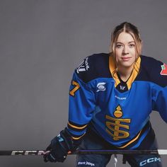 a female ice hockey player posing for a photo