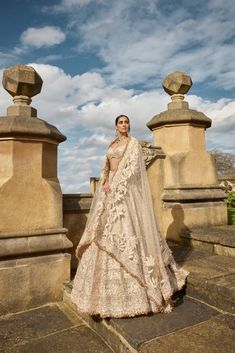 This lehenga set features all-over rose gold metallic work with crystal, pearl, and sequin. The ensemble is paired with a full-sleeved blouse and shows tassels at the wrist and blouse waist and a matching net dupatta.From Seema Gujral's A Royal Affair collection. DELIVERY TIMEPlease allow 8-12 weeks for your outfit to arrive. FABRIC DETAILSNet Professional cleaning only. Rose Gold Lehenga, Glamorous Festive Dupatta With Gota Work, Glamorous Dupatta With Gota Work For Reception, Glamorous Gota Work Dupatta For Reception, Glamorous Wedding Sets With Gota Work, Glamorous Wedding Dupatta With Gota Work, Luxury Gold Unstitched Lehenga, Luxury Gold Sequined Lehenga, Metallic Gold Lehenga