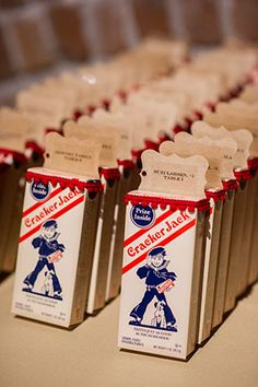 several packages of snacks are lined up on a table with red and white tags attached to them