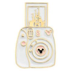 a white and gold mickey mouse pin with castle in the background, on a white background