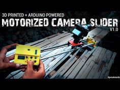 a person holding a yellow camera over a wooden pallet with the words, 3d printed arduo powered motorized camera slider v1