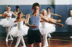 a group of young ballerinas standing around each other