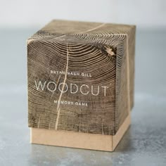 a wooden block sitting on top of a table next to a bottle of woodcut