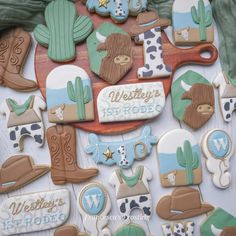 decorated cookies are arranged on a table for western themed birthdays and baby shower parties