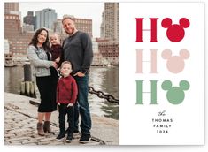 a family is posing for a photo in front of the water with their name on it