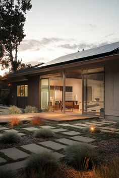 a modern house with an open patio at dusk