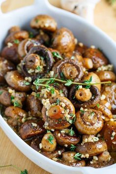 the dish is full of mushrooms and garnished with parsley