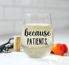 a wine glass with the words because patients on it next to strawberries and corkscrews