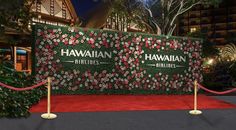 a red carpeted entrance to a hotel with a sign that says hawaiian airlines on it