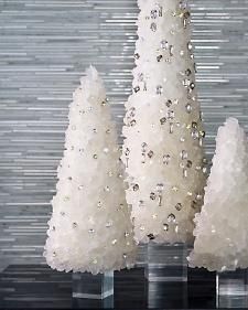 three white christmas trees are sitting on a table