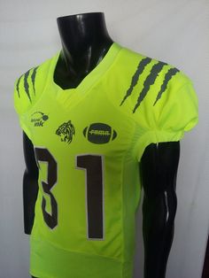 a mannequin wearing a neon green football jersey with monster numbers on the front