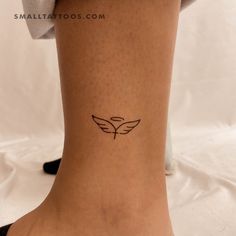 a woman's foot with a small tattoo on the side of her leg,