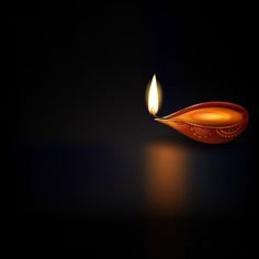 a lit candle on a black background