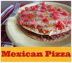 mexican pizza on a plate with a fork and knife next to it, in front of an advertisement for the restaurant