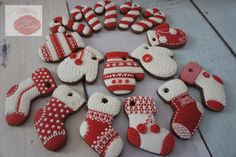 red and white decorated cookies are arranged in the shape of christmas stockings, mittenss and stocking caps