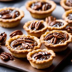 small pecan pies on a wooden cutting board