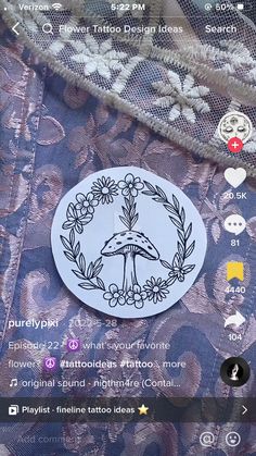 an image of a sticker that is on the back of a jacket with flowers and leaves around it