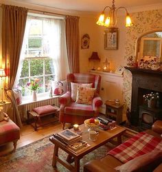 a living room filled with furniture and a fire place in front of a large window