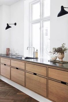 a kitchen with wooden cabinets and white walls