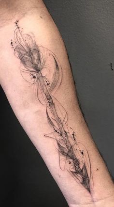 a man's arm with an arrow and stars tattoo on the left side of his arm