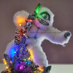 a white stuffed animal with christmas lights on it's head