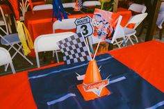 an orange cone shaped centerpiece sitting on top of a table