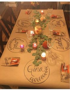 the table is set with candles and place mats for guests to sit down at it